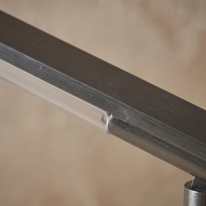 Macro detail of the Orsanne table lamp aluminum body meeting its polycarbonate diffuser