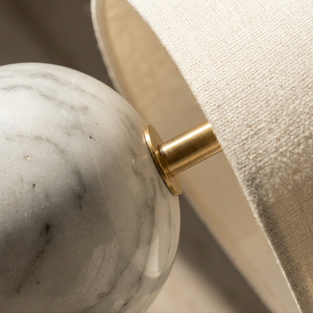 Rivelle table lamp close-up of marble base veining and fabric shade texture