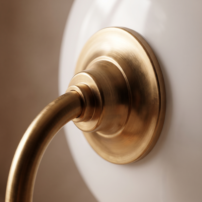 Macro detail of the Bellamira table lamp warm brass-toned metal finish where shade meets stem
