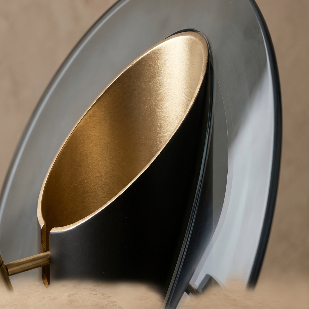 Close-up detail of Amberlyn table lamp brushed gold angled cut and smoke gray glass