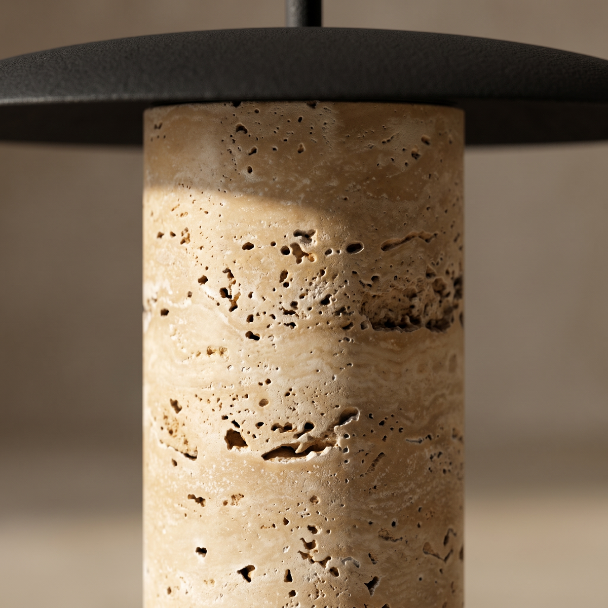 Close-up of Marcheva table lamp yellow travertine stone texture and black disc edge