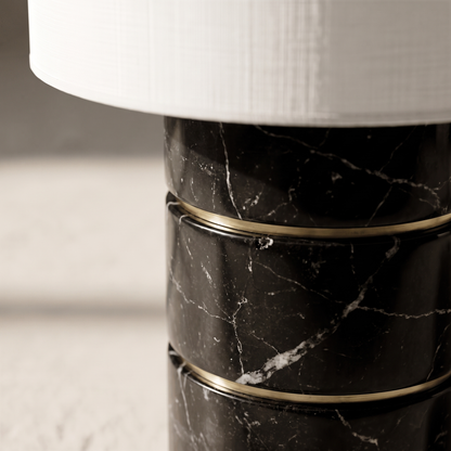 Macro detail of the Cavour lamp's veined black marble segments and brass accent ring