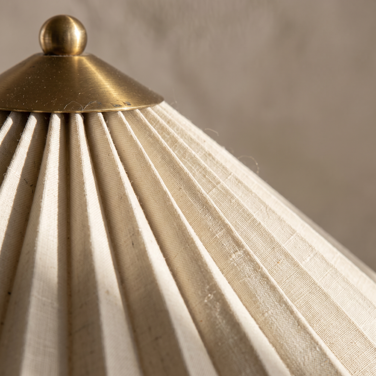 Close-up of the Aurelle table lamp pleated fabric shade texture and metal frame