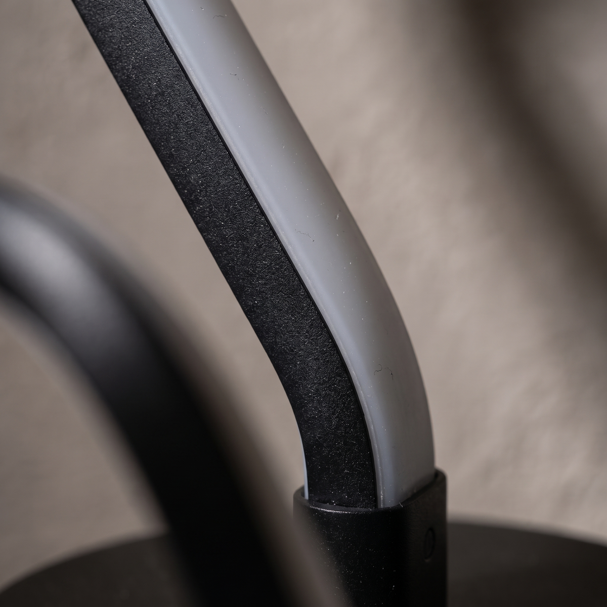 Close-up of the Noirelle table lamp black powder-coat finish and silicone LED diffuser