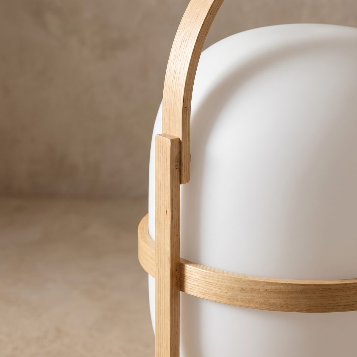 Close-up detail of the Galante table lamp glass and natural wood grain