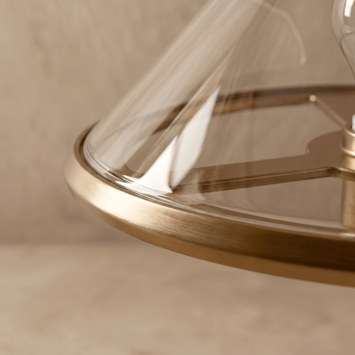 Close-up detail of the Herriveau table lamp bronze aluminum frame and glass shade