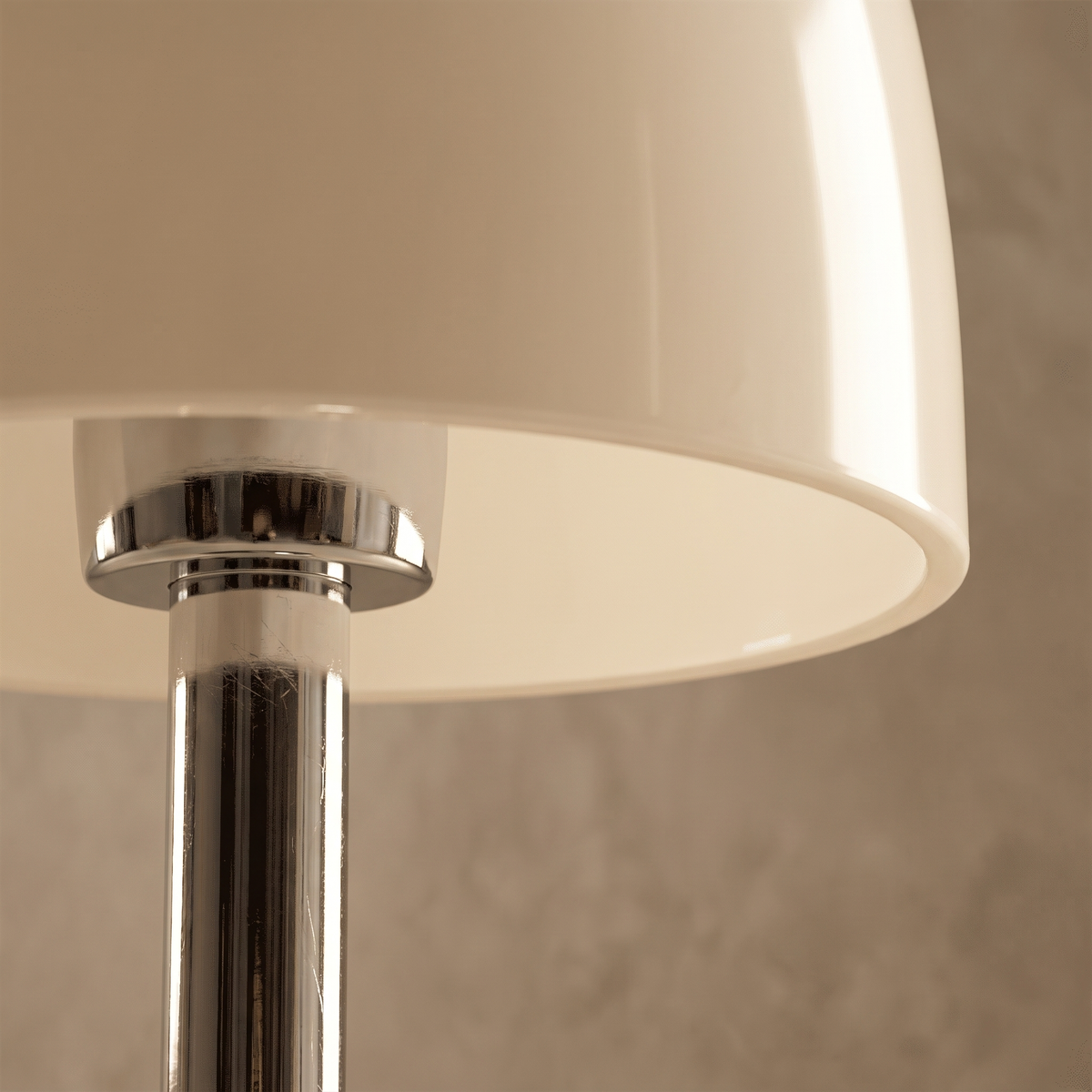 Close-up detail of the Fiorente table lamp cream glass shade meeting its polished chrome stem