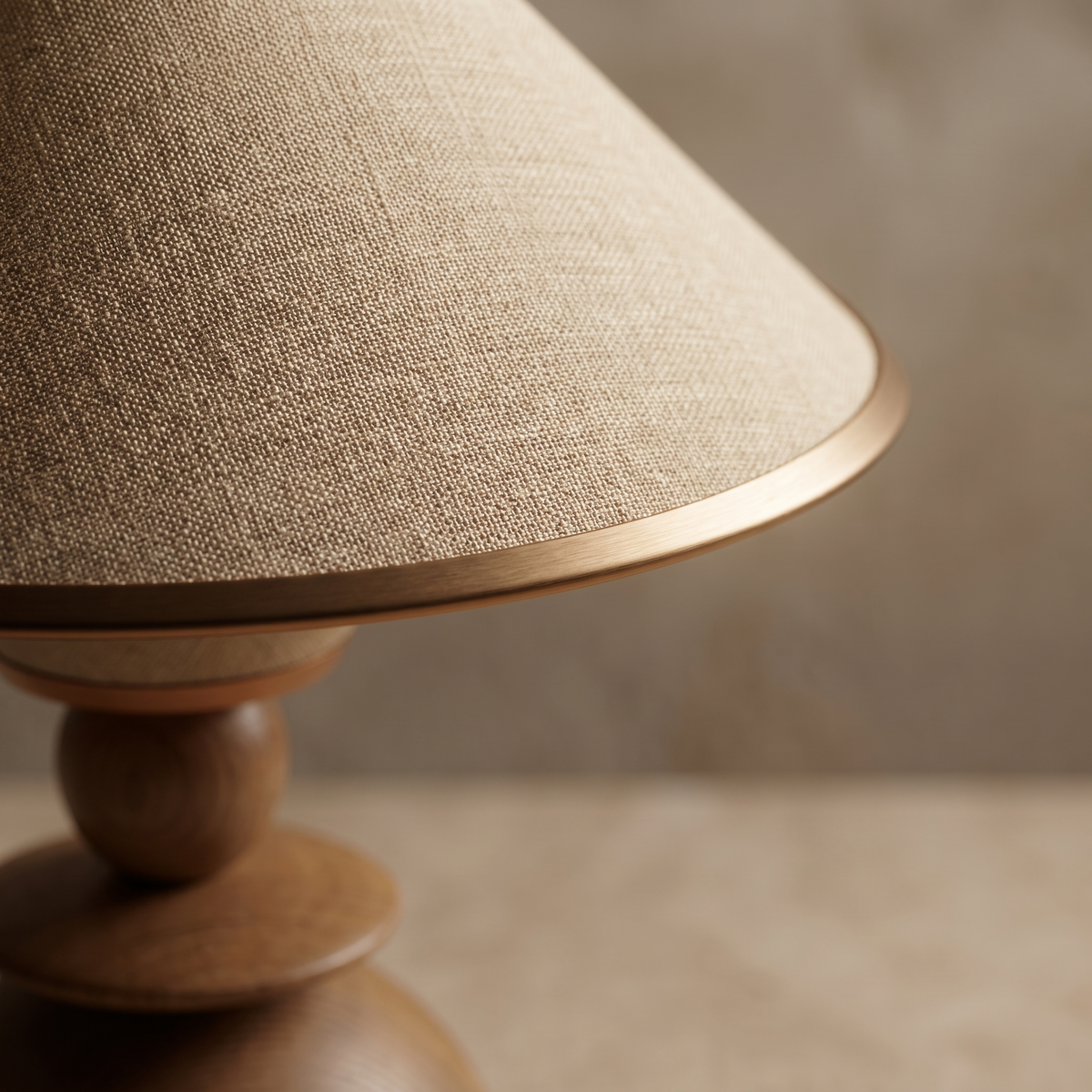 Close-up detail of the Jouvelle table lamp woven beige fabric shade and metal frame