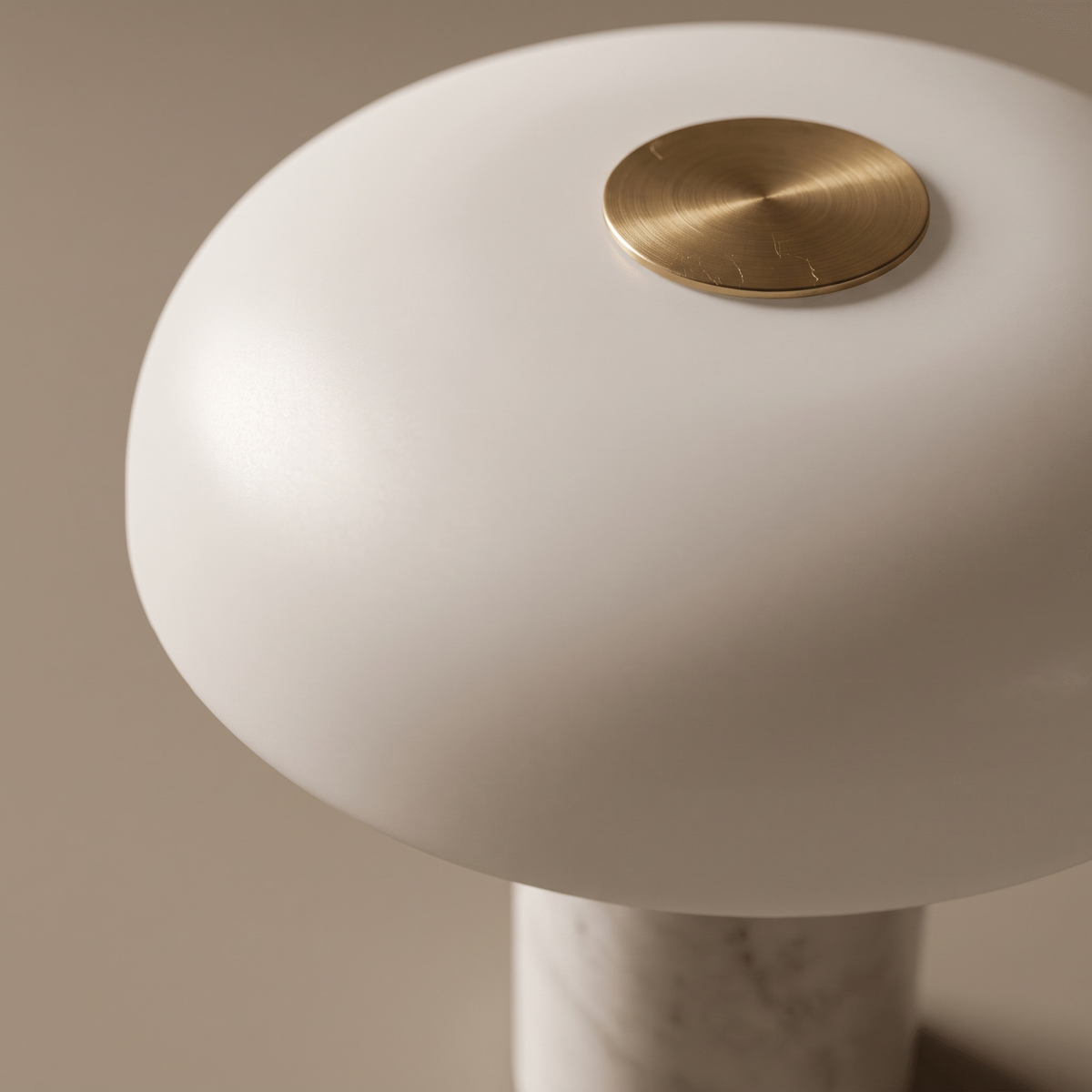 Umbriel table lamp detail, brass top disc and opal white dome shade close-up