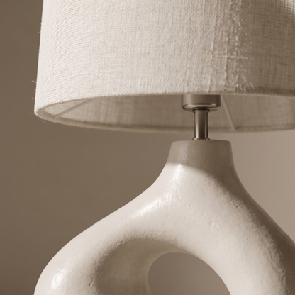 Ysoline table lamp macro, fabric shade meeting sculpted resin base detail