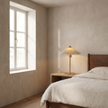 Aurelle mid century fabric table lamp glowing warm on an oak nightstand in a mid-century bedroom