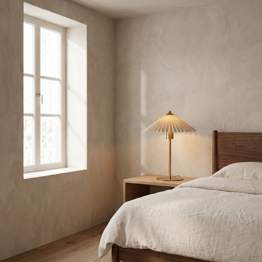Aurelle mid century fabric table lamp glowing warm on an oak nightstand in a mid-century bedroom