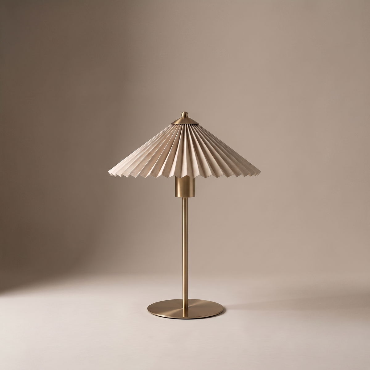 Aurelle mid century fabric and metal table lamp with pleated shade on a neutral studio backdrop