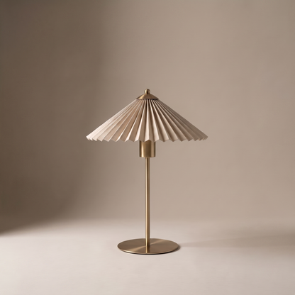 Aurelle mid century fabric and metal table lamp with pleated shade on a neutral studio backdrop