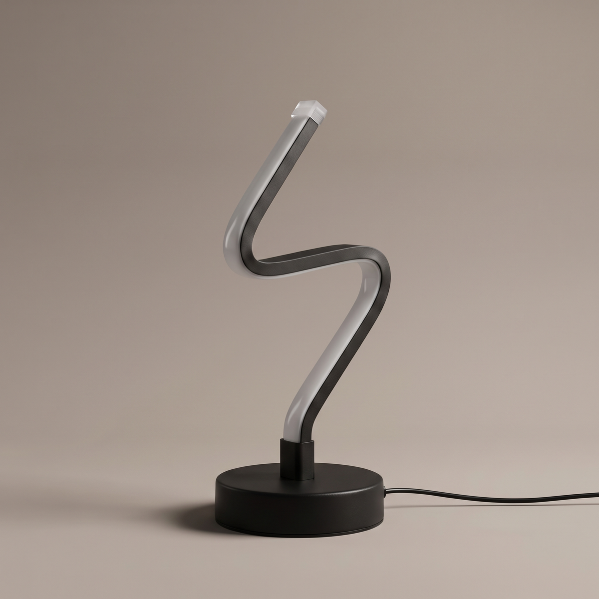 Noirelle sculptural black powder-coated aluminum LED table lamp on a neutral studio backdrop