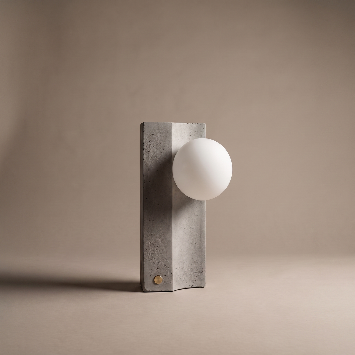 Solenne modern rechargeable table lamp in concrete and glass, studio product shot