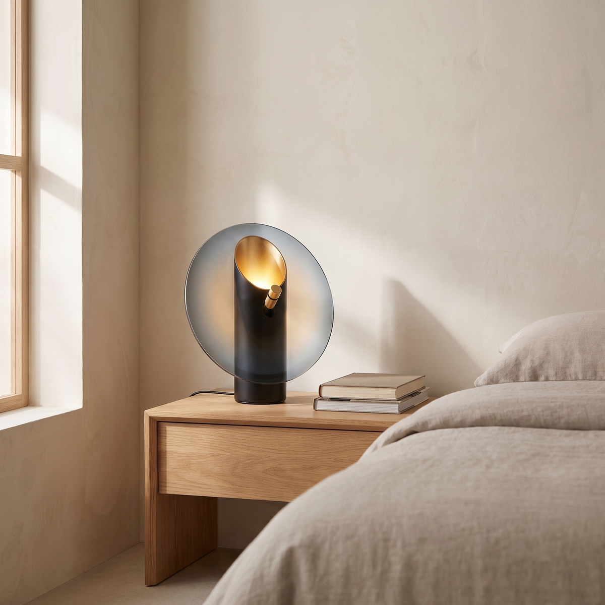 Amberlyn modern glass table lamp glowing warm on an oak bedroom nightstand
