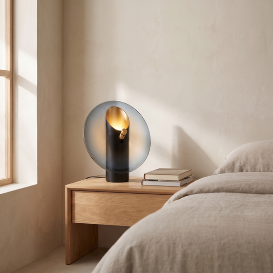 Amberlyn modern glass table lamp glowing warm on an oak bedroom nightstand