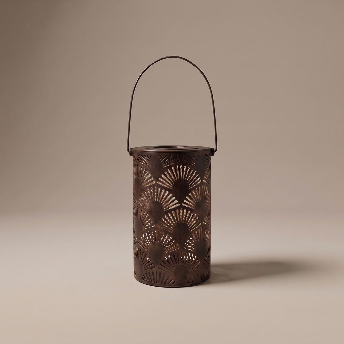 Lucerna bronze outdoor garden lantern with ornate cutouts on a neutral studio backdrop