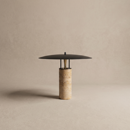 Marcheva marble and travertine table lamp with flat black disc on a neutral studio backdrop