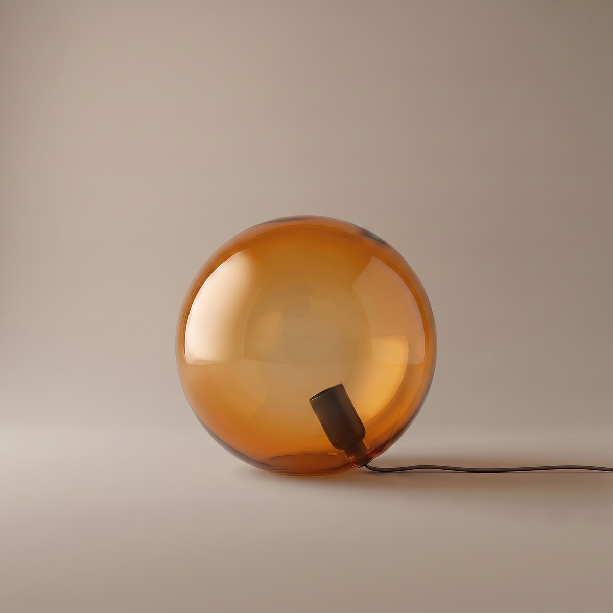 Oriane amber glass sphere table lamp, 9.8 inch orb, studio product shot on greige backdrop