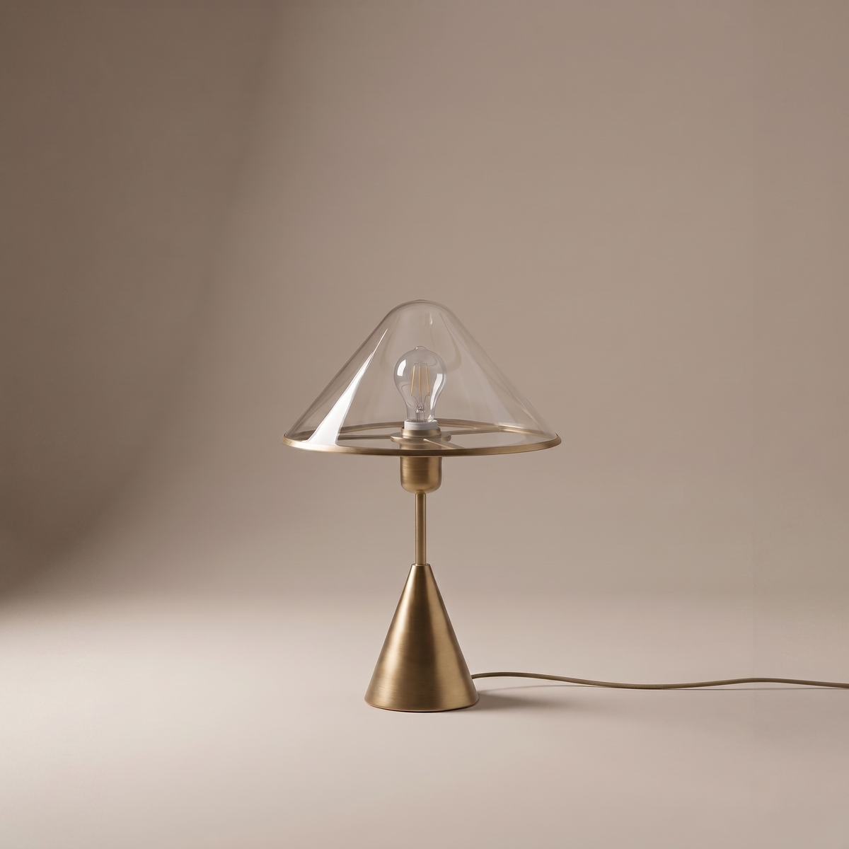 Herriveau table lamp in bronze-finished aluminum and glass, clean studio view on neutral backdrop