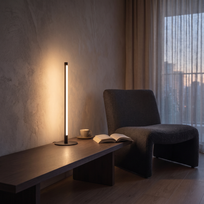 Nervesa modern LED table lamp lit at dusk on a smoked oak side table beside a lounge chair