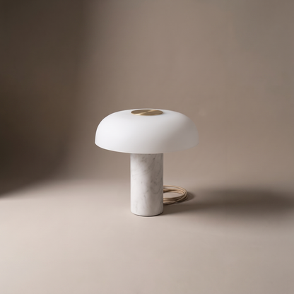 Umbriel modern table lamp with white dome shade and brass disc on stone base, studio product shot