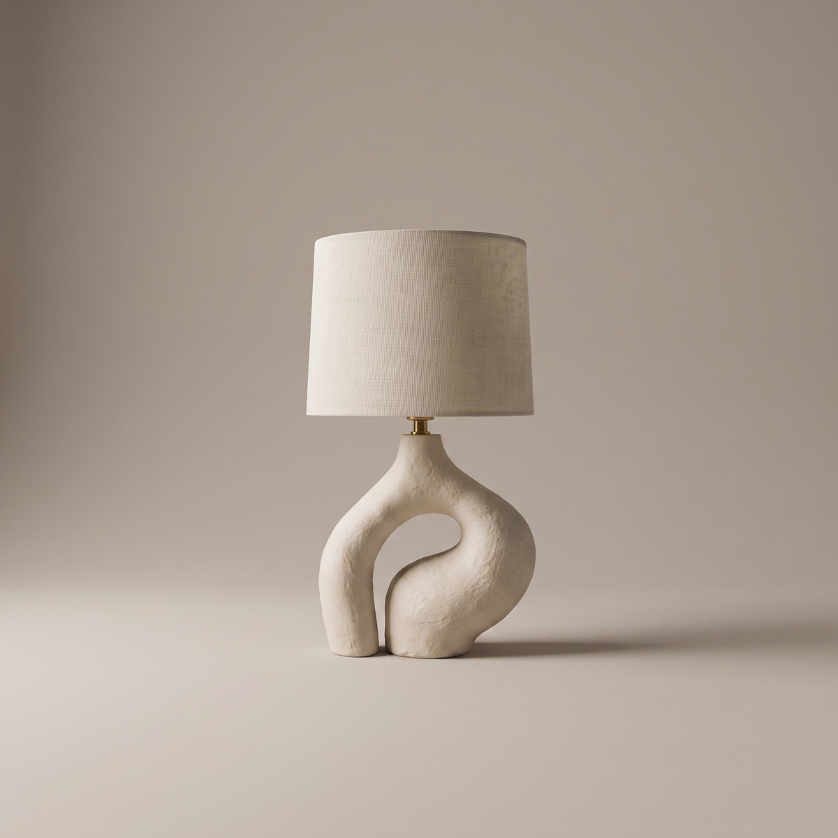 Ysoline table lamp with fabric shade and sculpted resin base, studio product shot