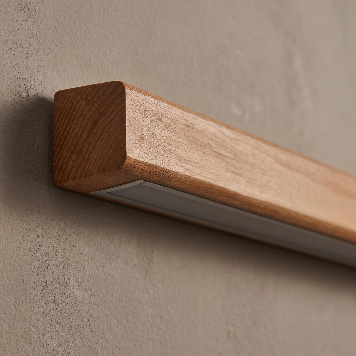 Close-up of the oak wood grain and recessed frosted LED diffuser on the end of the wood strip wall sconce