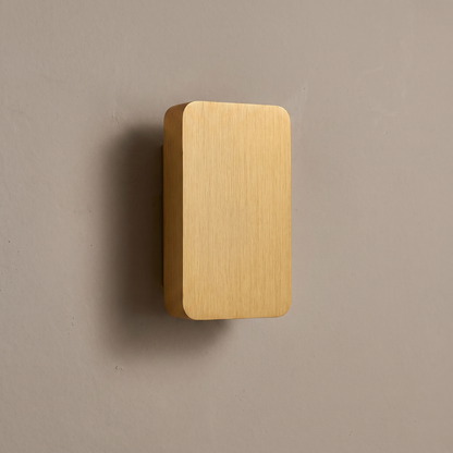 Brushed gold aluminum rectangular flat panel 2-light LED wall sconce mounted on a warm greige plaster wall, lamp off