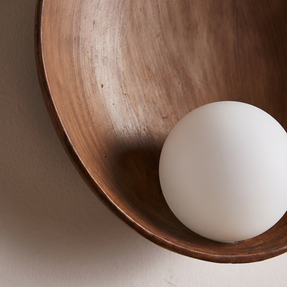 Modern minimalist round wood-grain resin wall sconce — close-up of the hand-painted wood grain dish and frosted glass globe