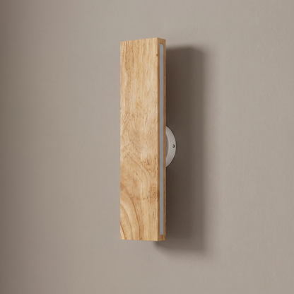Nordic rotatable solid oak LED bar wall sconce, lamp off, mounted vertically on a plain greige plaster wall showing the round pivot base