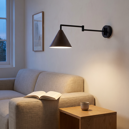 Nordic black iron swing arm wall sconce with wood-grain cone shade lit at dusk over a linen sofa in a living room reading corner