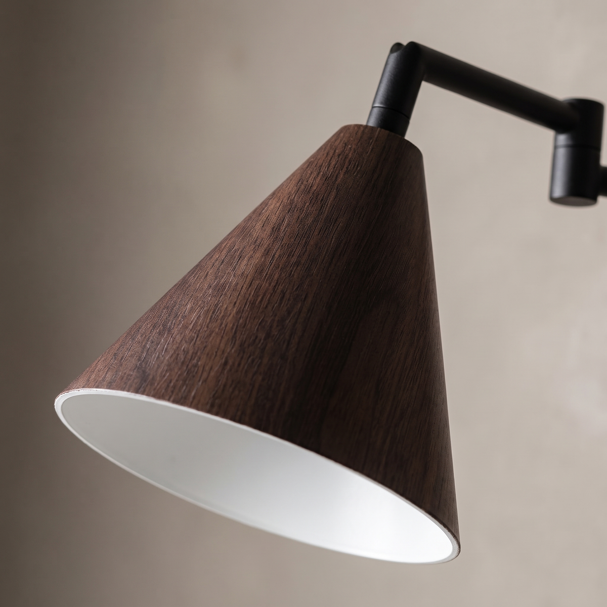 Nordic black iron swing arm wall sconce — close-up of the walnut wood-grain cone shade, white interior and matte black stem