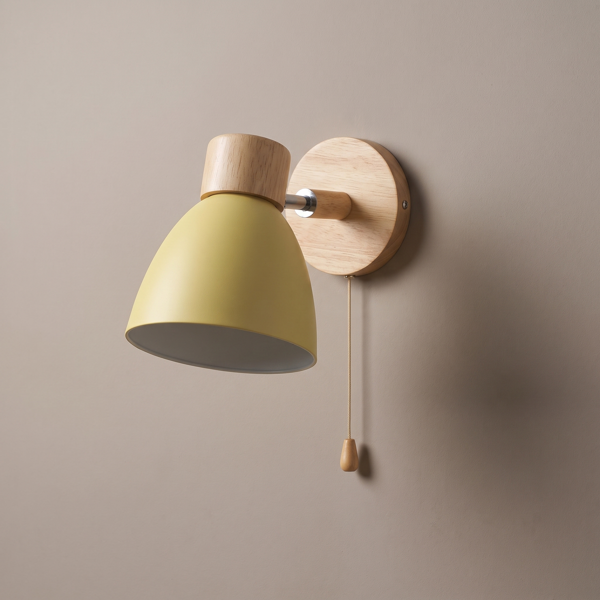 Modern minimalist macaron yellow dome wall sconce with natural wood cap, wood canopy and zipper pull switch on a plaster wall, lamp off