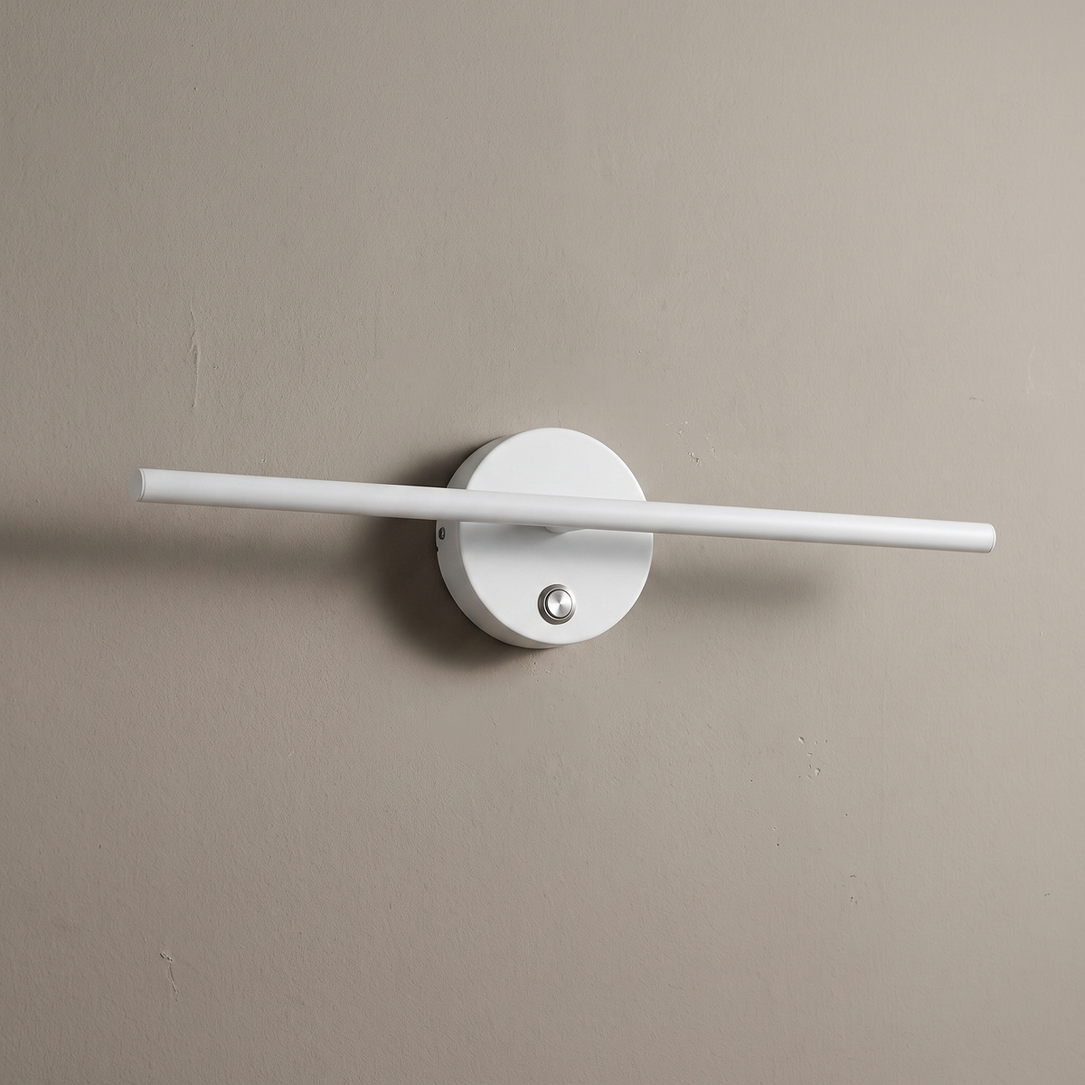 Nordic minimalist white aluminum long bar LED wall sconce with round switch backplate, lamp off on a warm greige plaster wall