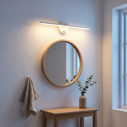 Nordic white aluminum LED mirror front wall light mounted above a round oak mirror in a Scandinavian bathroom