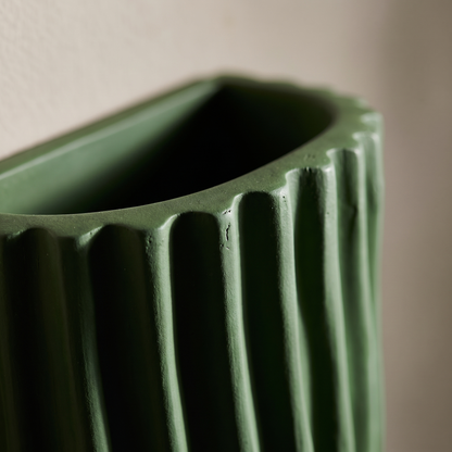 Close-up of the vertical ripple texture and open top rim of the green resin half cylinder wall light