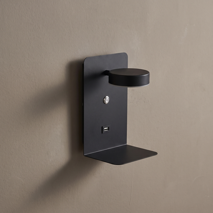 Modern square black iron LED wall sconce with shelf, rotatable spotlight head and USB port on a plain greige wall, lamp off