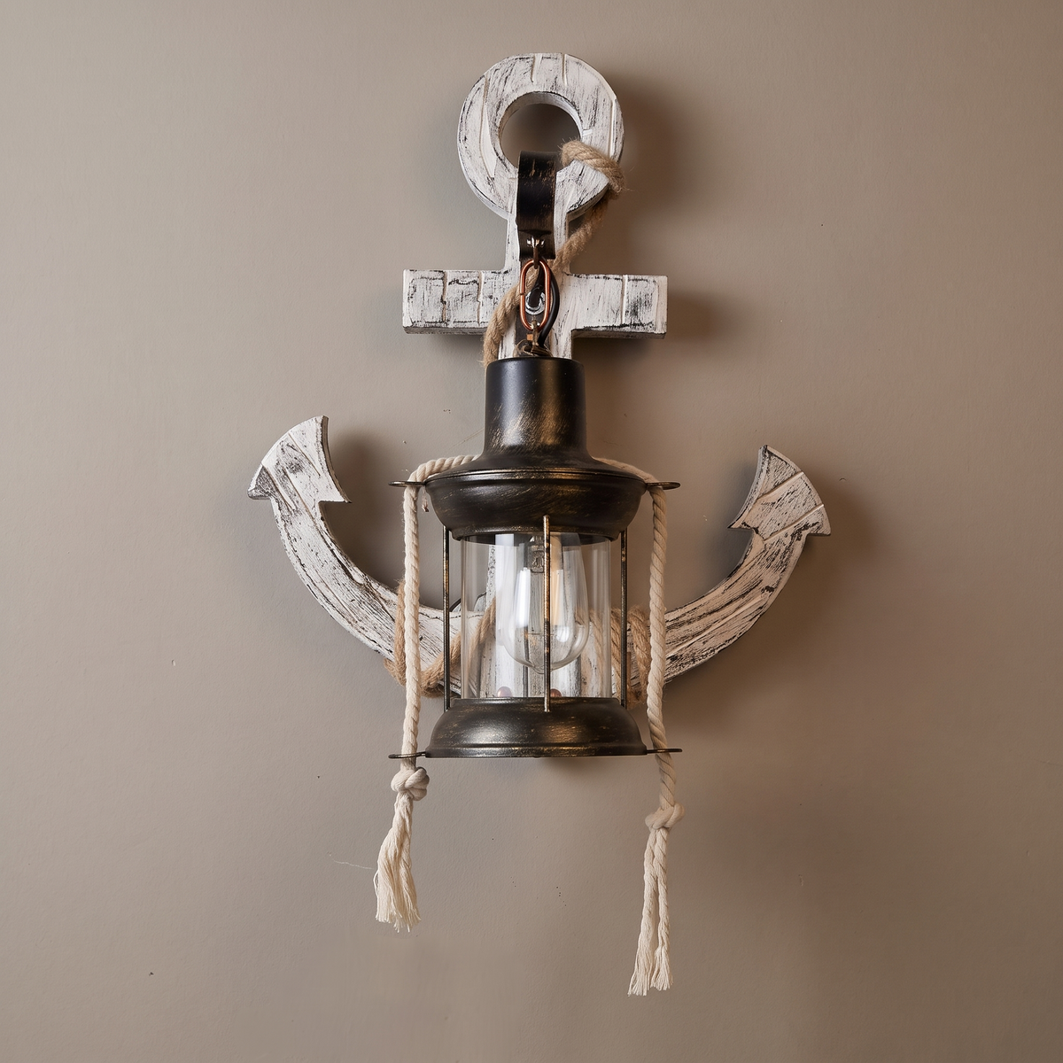 White-washed solid wood boat anchor wall sconce with rope wrap and black iron lantern cage on a plain greige wall, lamp off