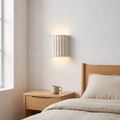 Nordic white fluted resin tiles 2-light wall sconce glowing warm up and down the wall beside a light oak bed and nightstand