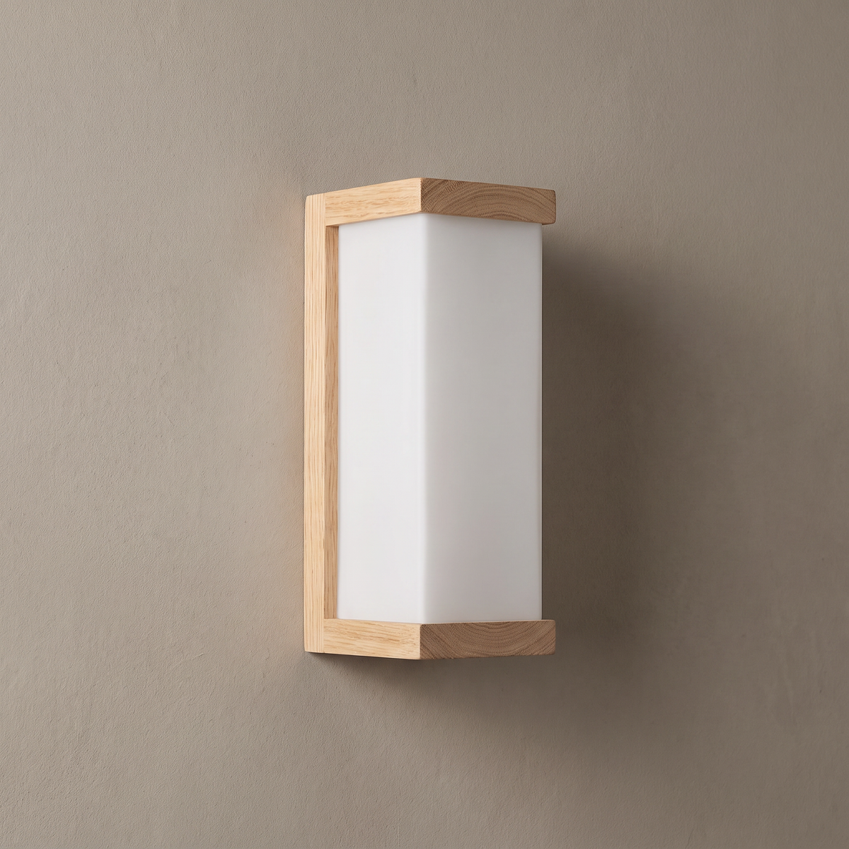 Natural oak wood and square white frosted glass column wall sconce on a plain greige plaster wall, lamp off